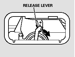 Push the release lever to the lower right as shown.