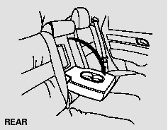 The rear seat armrest is in the center of the rear seat. Pivot it down to use