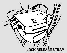 3. Unlock the seat from the floor by pulling the lock release strap located at