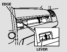 Open the upper glove box by pushing up the lever. Close it by pulling down on