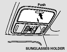 To open the sunglasses holder, push then release the raised detent. It will unlatch