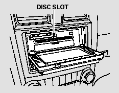 Insert a disc about halfway into the disc slot. The drive will pull the disc
