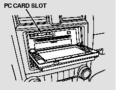 The PC card slot is behind the navigation screen. To use the PC card player,