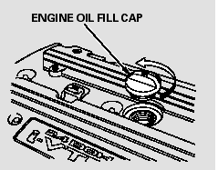 Unscrew and remove the engine oil fill cap on top of the valve cover.