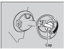 4. Remove the fuel fill cap slowly. If you hear a release of air, wait until