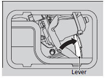 2. To open the tailgate, push the tailgate while sliding the lever to the right.